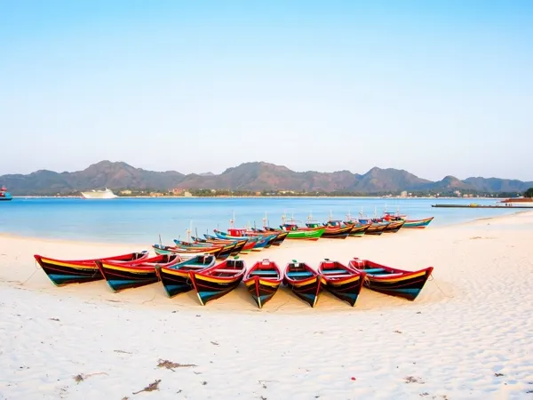Colourful fishing boats drawn up on the pale sand of Jimbaran Bay